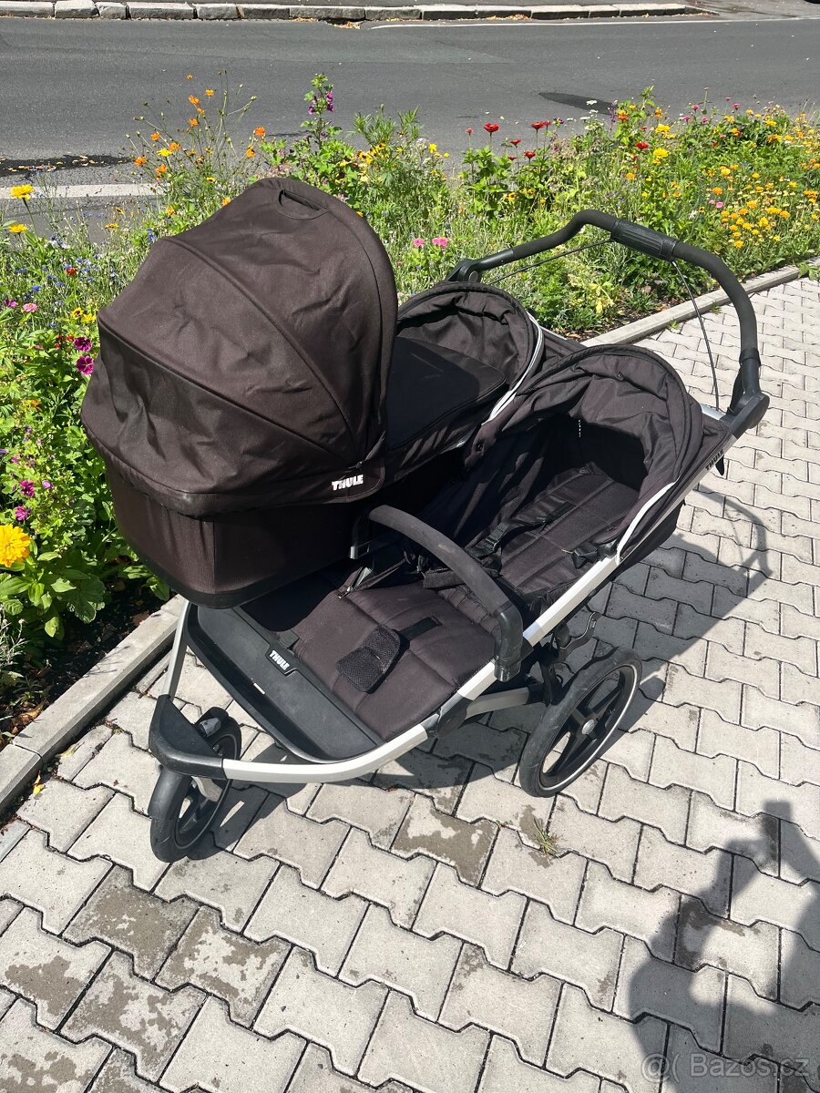 Dvoumístný kočárek Thule s jednou nasazenou hlubokou korbou a jedním sportovním sezením